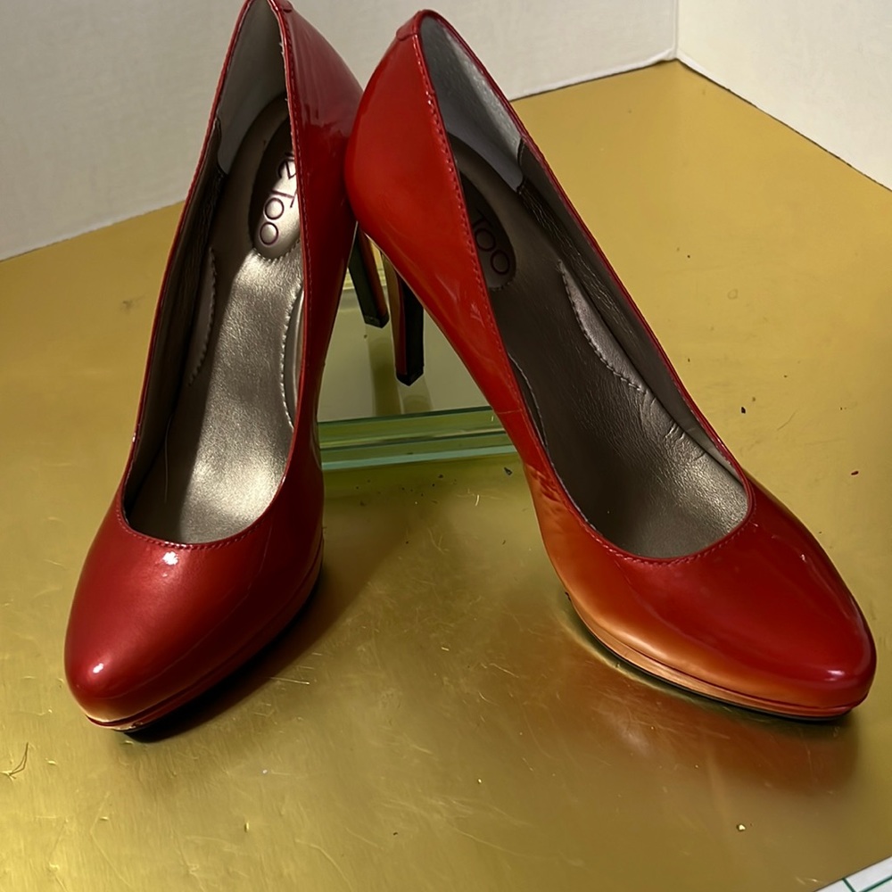 A brand new never worn orange patent leather heel by me too